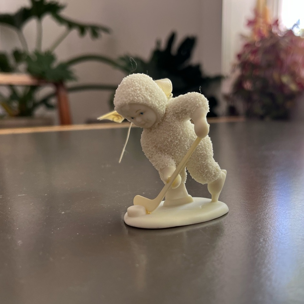 Department 56 Hockey Baby Figurine with Yellow Ribbon